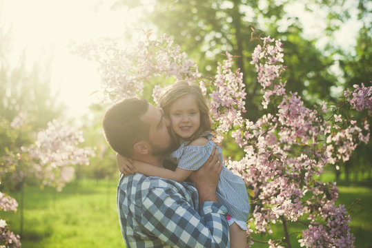 father kissing little daughter
