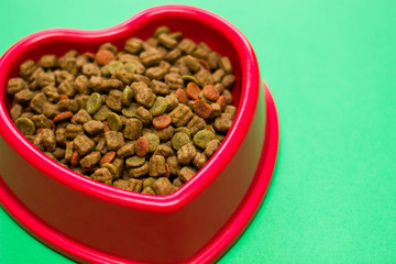 Red bowl full of multicolored dog food