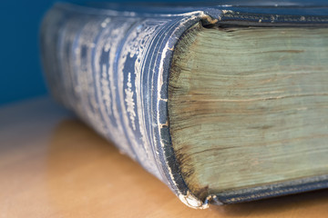 Closeup of old antique large book and design on spine