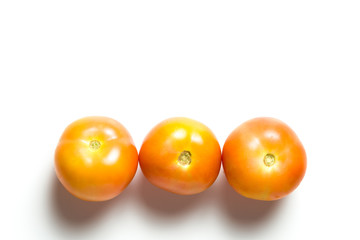 A group of tomatoes isolated over white background