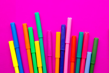 Art - colored pens on pink background
