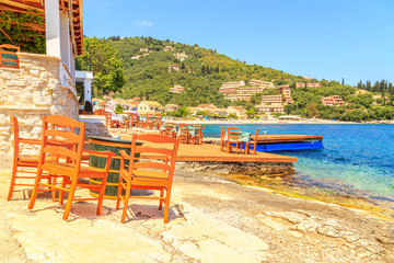 Table and chairs next to the beach in Corfu, Greece