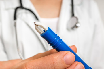 Female doctor is holding tweezers with a tick