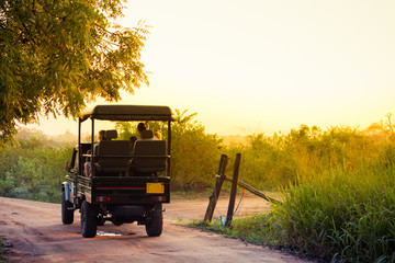 An open topped jeep carries tourists into the national park of Udawalawe, Sri Lanka to search for wildlife in the park.