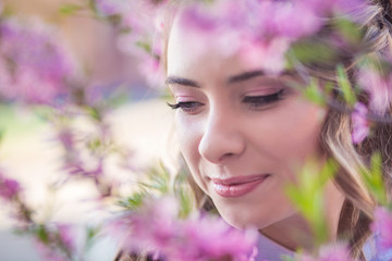 Fototapeta premium A girl in a blooming garden