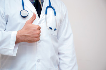 close up of male doctor hand showing thumbs up.