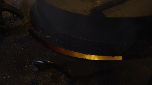 Closeup Of Heating Flaxseed To Produce Oil, Inside 18th Century Windmill At UNESCO World Heritage Site, Kinderdijk, The Netherlands