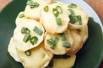 Appetizer of potatoes, cheese and green onions. There is room for text