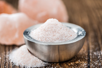 Himalayan Salt on wooden background (selective focus)
