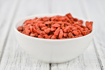 Goji Berries (selective focus) on vintage wooden background