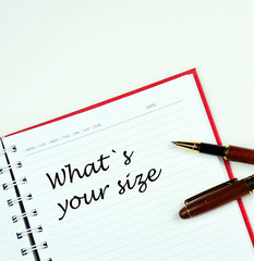 Communication message motivation concept with " Whats your size " word on notebook.