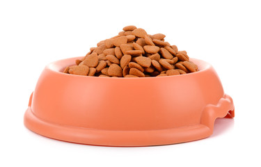 dry dog food in orange bowl isolated on white