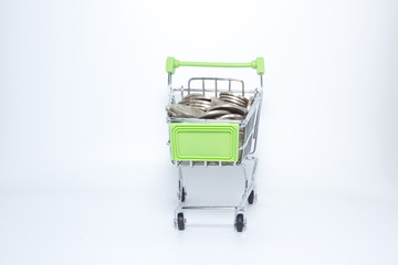 Isolated Picture : Mini Supermarket Cart with Pile of coins.