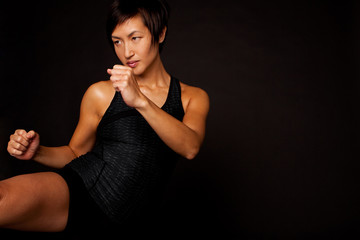 Fototapeta premium Portrait of woman practicing self defense.