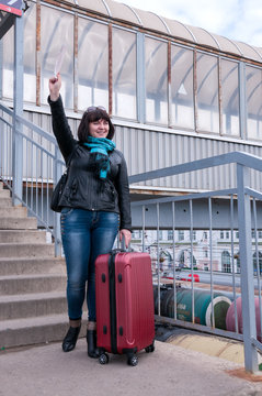 Woman is standing on a platform and waving her hand