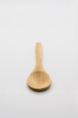 Wooden spoon over white background.