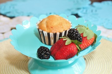 Fresh baked muffins with blueberries and strawberries