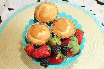 Fresh baked muffins with blueberries and strawberries