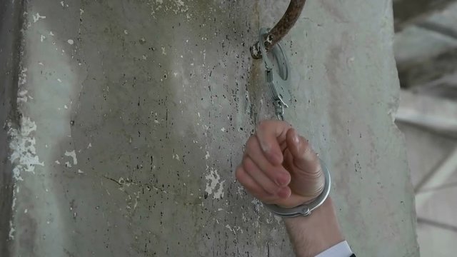 Hand of a man in handcuffs