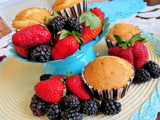 Fresh baked muffins with blueberries and strawberries