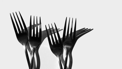 Fork and spoon in black and white / spoons are the primary utensil used for eating and forks are used to push foods