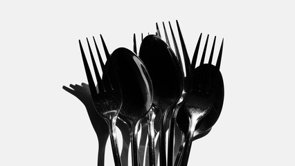 Fork and spoon in black and white / spoons are the primary utensil used for eating and forks are used to push foods