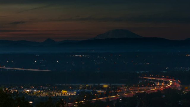 Ultra high definition 4k time lapse movie of interstate 205 freeway traffic along Glen L. Jackson bridge over Columbia River from sunset into night with light trails 4096x2304