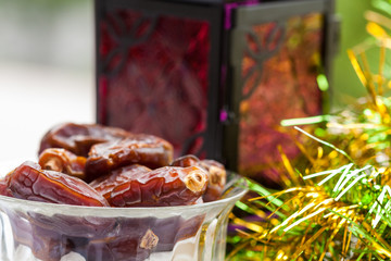 Closeup of date fruits in glass bowl. Ramadan, Eid concept background