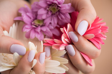 woman hands with manicure holding flower