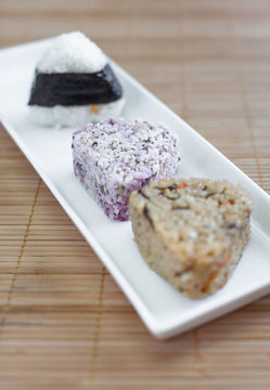 Onigiri , Japanese food rice ball made from white rice formed into triangular or cylindrical shapes. And often wrapped in nori (seaweed).