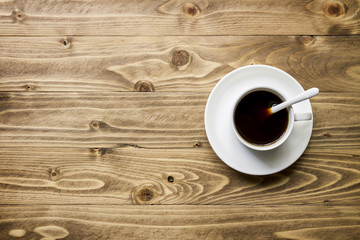 Hot coffee on wooden table