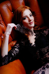 Dramatic sensual redhead woman in black lace peignoir