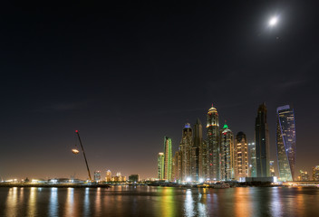 Fototapeta premium Dubai Marina waterfront in moonlight. May 2017
