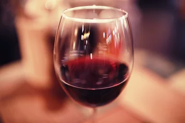 Fotobehang Serving a glass of red wine in a restaurant © kichigin19
