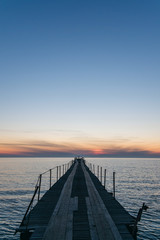 Vacation and Holiday concept - Wooden pier between sunset