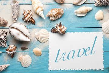 Marine summer postcard. Seashells on blue wooden boards in the sand on the beach