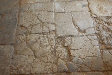 The old gray cracked covering of asphalt