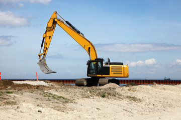 Excavator works on a construction site with excavation