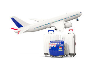 Luggage with flag of cayman islands. Three bags with airplane
