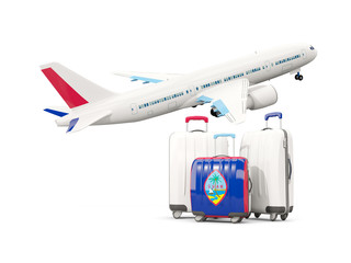 Luggage with flag of guam. Three bags with airplane