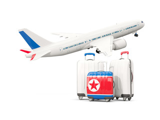 Luggage with flag of korea north. Three bags with airplane