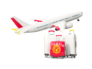 Luggage with flag of kyrgyzstan. Three bags with airplane