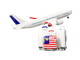 Luggage with flag of malaysia. Three bags with airplane