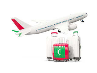 Luggage with flag of maldives. Three bags with airplane