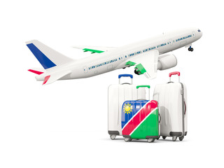 Luggage with flag of namibia. Three bags with airplane