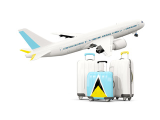 Luggage with flag of saint lucia. Three bags with airplane