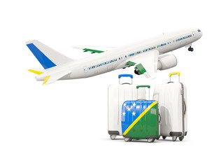 Luggage with flag of solomon islands. Three bags with airplane