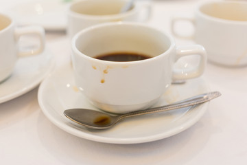 Soft focus and blurred photo of dirty used coffee cups after finished coffee break time.