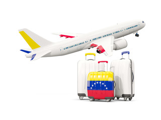 Luggage with flag of venezuela. Three bags with airplane