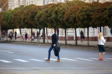 Hipster guy walking down the street, urban style